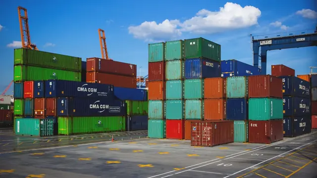 Stacked shipping containers at an industrial dock, echoing Docker's container metaphor