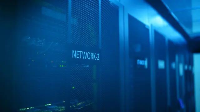 Modern server room with network equipment lit in blue