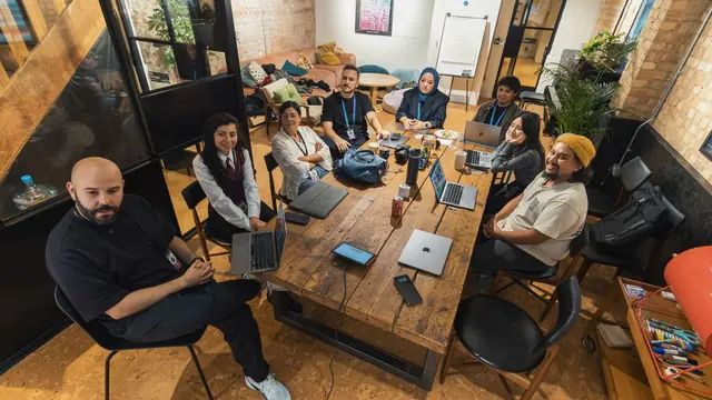 Team of engineers and product staff collaborating in a modern office