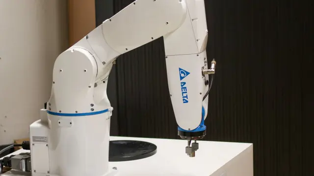 Industrial robotic arm operating in an automated production setup