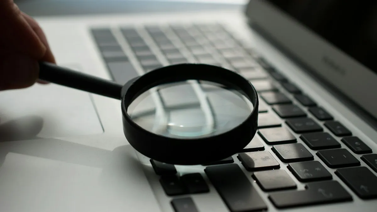 A magnifying glass held over a laptop keyboard