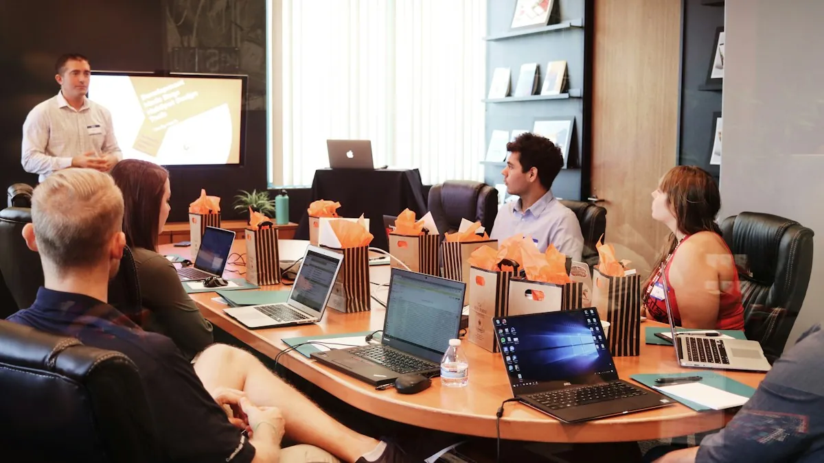 A team in a meeting room listening to a colleague present