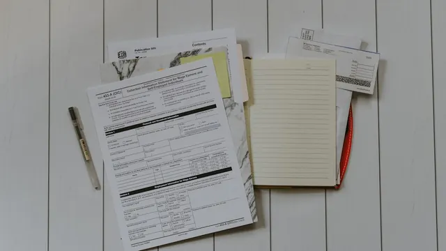 A stack of printed forms and paperwork on a desk