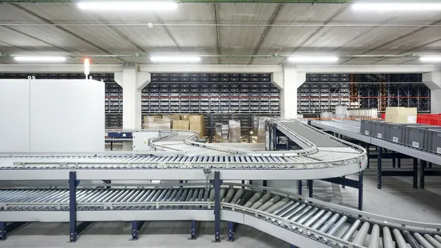 A conveyor belt running through a warehouse