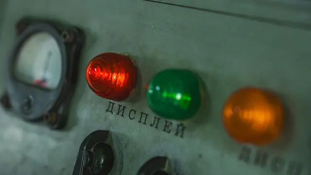 Red, green and orange indicator lights on a control panel